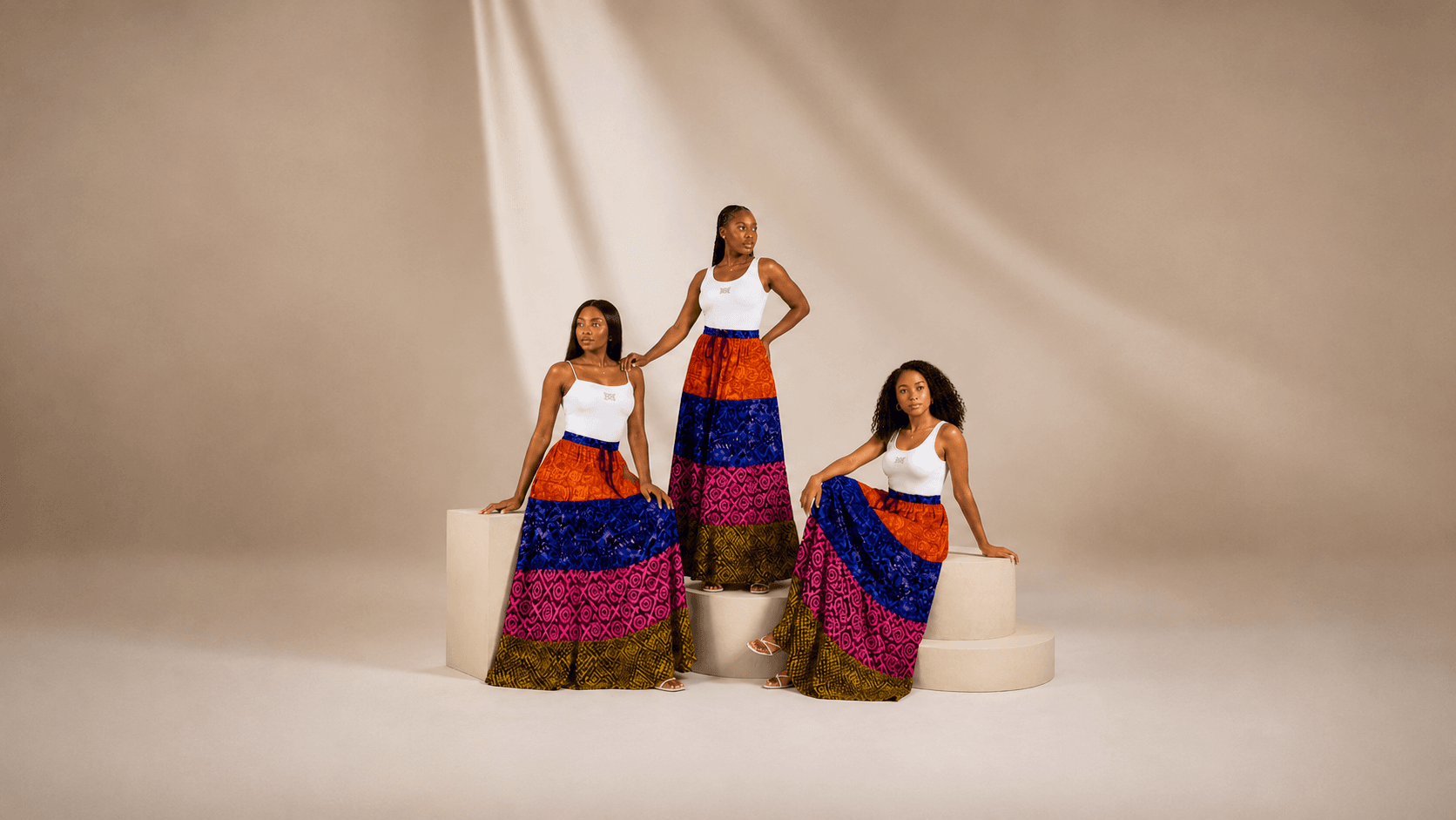 Girline Collection — three women in Ankara print skirts